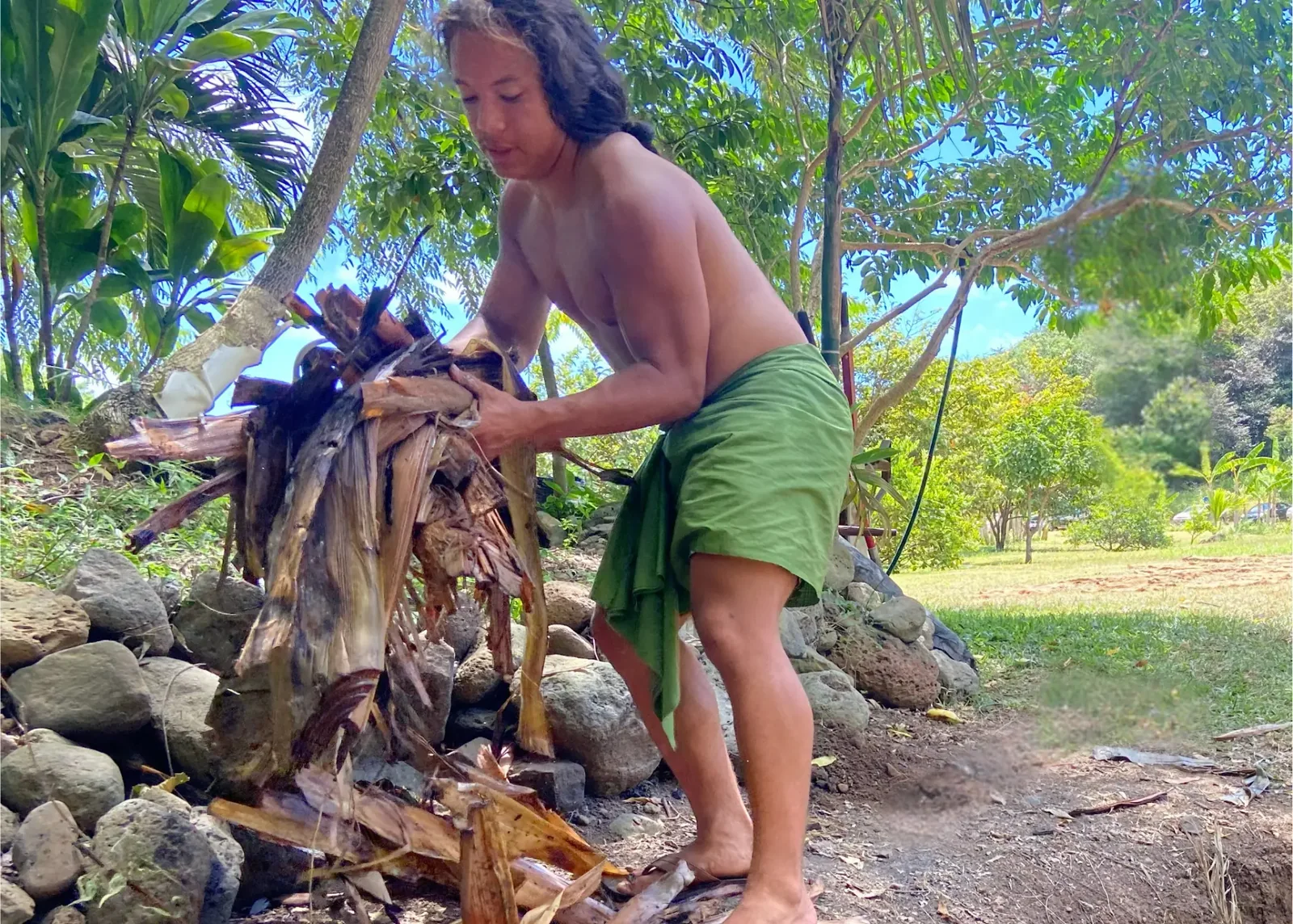 Tua carrying plant debris into the Black Gold composting project.