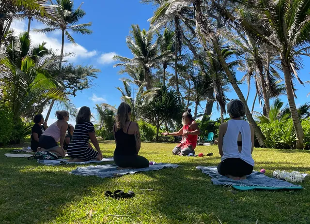 Community members seated outdoors during a CH³ Tension Release session in Lāʻie.