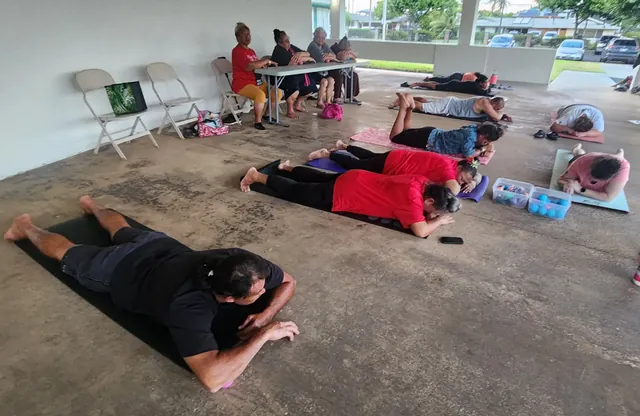 Kūpuna and adults using mats during a CH³ Tension Release session at Lāʻie Front Chapel.